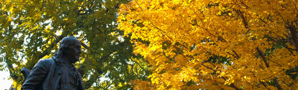 Statute of Ben Franklin with fall foliage